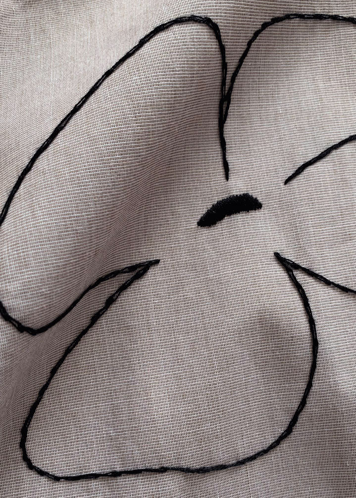 Close-up of the embroidered flower.
