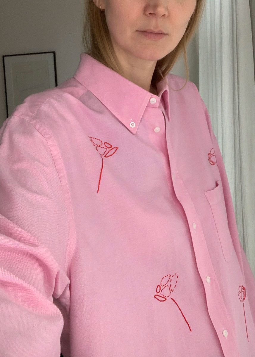 Close-up of pink shirt on person.