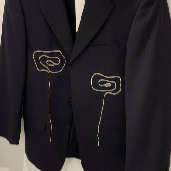 Video of blazer from front with hang tag.