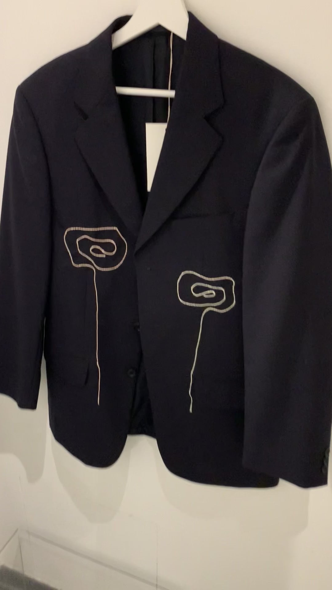 Video of blazer from front with hang tag.