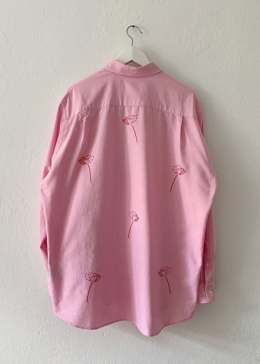 Pink shirt from back on hanger.