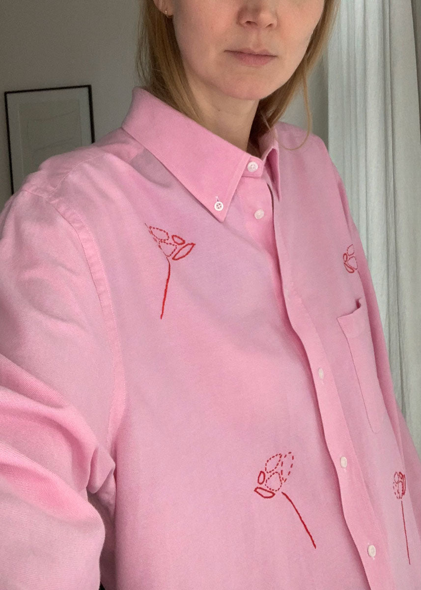 Close-up of pink shirt on person. 